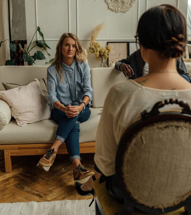 A therapist and client in discussion during a cozy indoor session highlighting mental health.